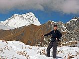502 Jjerome Ryan And First View Of Dhaulagiri From Thulo Bugin Returning To Lete Up at 6:00, -1C in tent, -5C outside, it lightly snowed again last night. Breakfast: fried eggs on pancake. Sun hit our camp at 8:20, left at 8:30. After the trek to Annapurna North Base Camp, I didn't think it could get worse, but it did. This morning's trek was worse. First of all, the snow covered the trail making it worse to walk. Secondly, where the snow had melted, it was slushy slippery mud. Thirdly, it was mostly downhill, steeply downhill. Add to that crossing raging streams, and a few falls (mine, that is), and by the time I arrived at our lunch stop at 11:50, I was both mentally and physically spent. After a lunch of French fries, pan-fried bread and yak cheese, we left at 13:25, arrived at the April 27 pass at 14:55, and down to the Shepherd�s Kharka camp at 16:15.